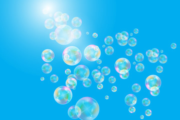 Realistic soap bubbles with rainbow reflection set isolated on the blue background.