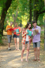 Fototapeta premium group of students discussing exam questions standing in the Park