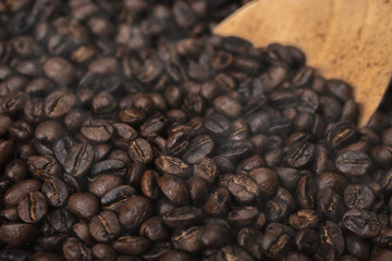 Roasted coffee beans with wooden spoon
