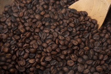 Roasted coffee beans with wooden spoon