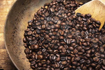 Roasted coffee beans with wooden spoon