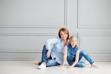 The beautiful woman with the daughter indoors with an interior