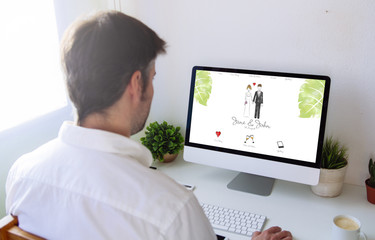man browsing wedding website on computer