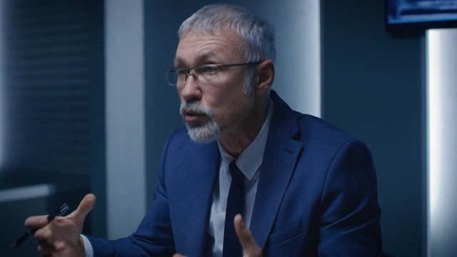 Portrait of the Corporate Businessman having Heated Debate with His Business Partners During Weekly Meeting. Serious Business People: Problem Solving, Negotiating and Strategizingю