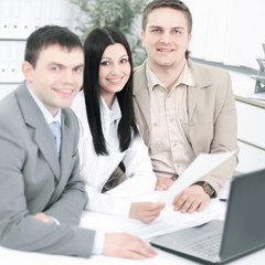 Fototapeta premium employees discussing financial charts sitting at their Desk
