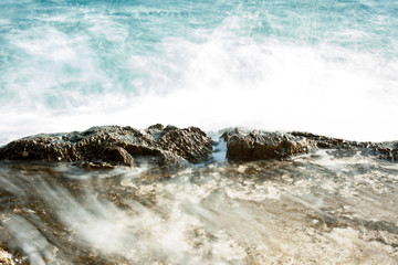 Waves crushing against the rocks at Adriatic coast. Long exposure with motion blur, no horizon