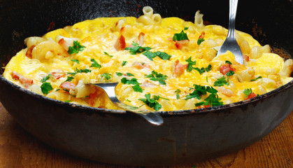 Traditional rustic omelette with bacon, pasta and greens