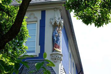 Historic building facade with beautiful architectural details. The Madonna and Child. Architecture and nature. Street photography.