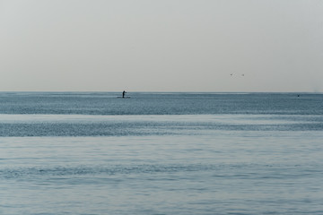 Lone paddle board on Mediterranean