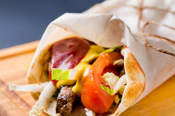 giras with vegetables and meat, sprinkled with sauces