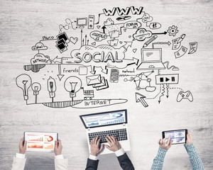 Top view of businesspeople sitting at table and using gadgets