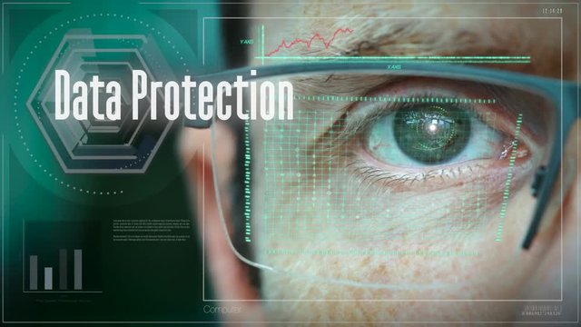 A close up of a businessman eye controlling a futuristic computer system with an Data Protection concept.