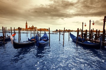 Gondolas in lagoon of Venice on sunrise