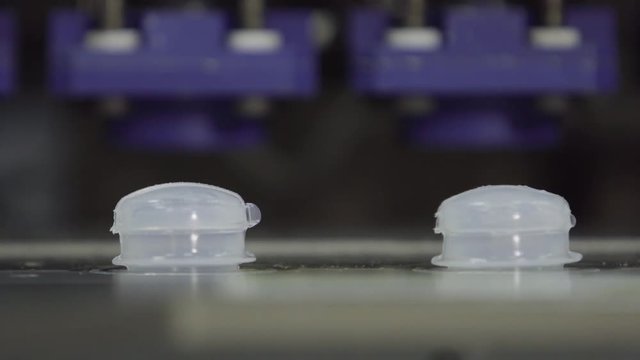 installation of caps on sterilized plastic bottles with medicine on the conveyor of the plant for the production of medical products and medicines with blow fill seal tecnology