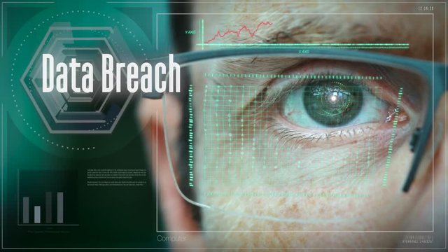 A close up of a businessman eye controlling a futuristic computer system with an Data Breach concept.