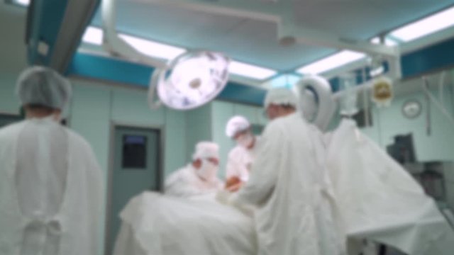 Blurred view of the operating room in hospital, surgeons perform surgery.
