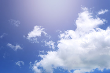 The sky with white clouds and illumination from the Sun