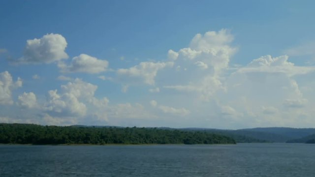 Time lapse the cloud moving in the bright sky day with mountain and lake