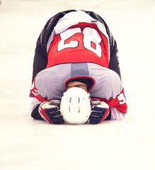 Kneeling ice hockey player.