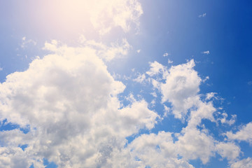 The sky with white clouds and illumination from the Sun