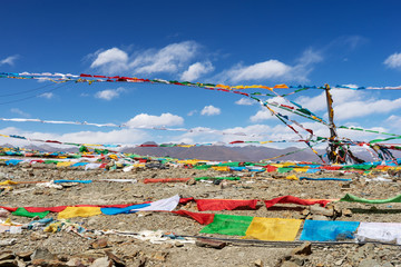 colorful flags in tibet with blue sky