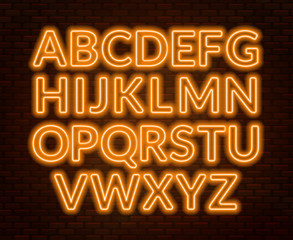 Neon yellow alphabet on brick wall background. Capital letter.