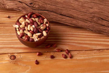 walnut peanut in clay bowl. peanuts for food textures. peanut harvest. fried peanuts. texture of the nuts. photo for layout. Copyspace