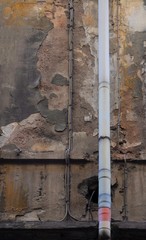 Old and damaged uninhabited building facade.