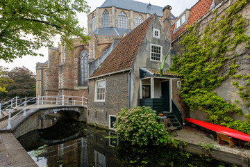 Obraz na płótnie Canvas One of the oldest houses in the center of Delft, the Netherlands, next to the church and on the canal