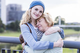Portrait of young woman hugging her  grandmother