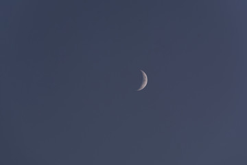Obraz na płótnie Canvas Crescent moon over blue sky