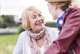 Portrait of happy grandmother talking to her granddaughter