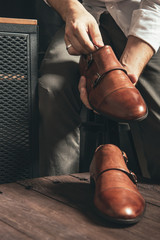 The shoemaker puts new monk shoes on the table