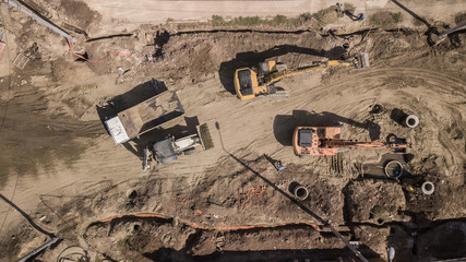 Aerial construction site with machinery. Top down view of city building site.