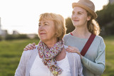 Portrait of senior woman with her granddaughter in the background