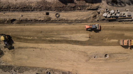 Aerial construction site with machinery. Top down view of city building site.