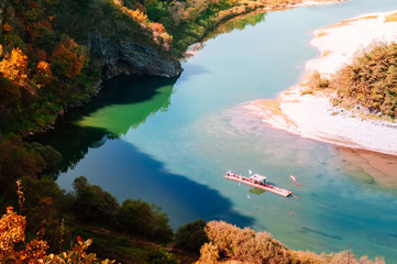 Boat rafting in Seogang river at Seonam village with autumn forest. Gangwon, South Korea