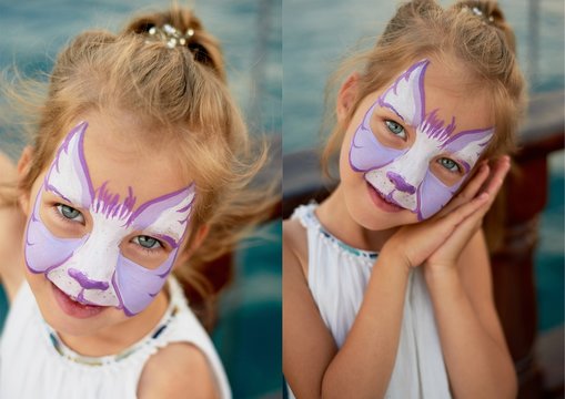 Pretty exciting blue-eyed girl of 5 years with a pink face painting