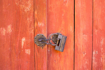 Old padlock at vintage wooden door