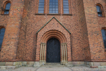 Fototapeta na wymiar Roskilde Cathedral is a cathedral of the Lutheran Church of Denmark. The first Gothic cathedral to be built of brick, it encouraged the spread of the Brick Gothic style throughout Northern Europe