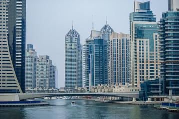 Fototapeta na wymiar Futuristic architecture of skyscrapers in Persian Gulf. Dubai marina cityscape panorama. Luxury buildings in modern emirates.