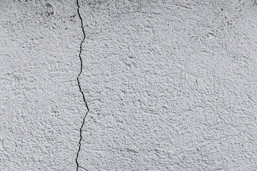 horizontal texture of a gray concrete wall with a large crack