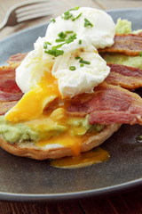 poached egg and bacon on bagel breakfast