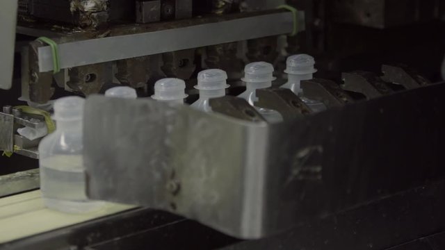 Sterilized clogged plastic bottles with medicine on the conveyor of Blow fill seal technology a manufacturing technique used to produce liquid-filled container on a medical or food industrial factory