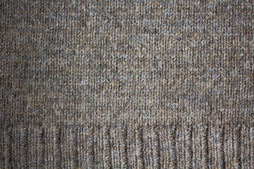 the texture of a knitted sweater, close up warm woollen clothing