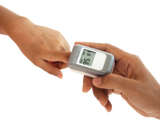 woman hand hold pulse oximeter for child used to measure pulse rate and oxygen levels , Patient with pulse oximeter on finger for monitoring