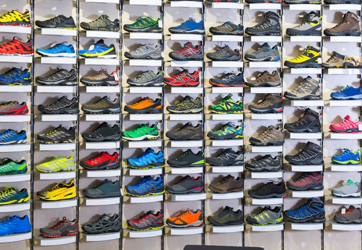 Image of big selection of sport shoes in market.