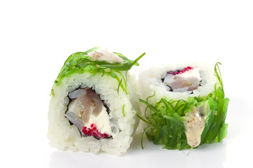 Menu of the Japanese restaurant. Two traditional sushi rolls with a variety of fillings sprinkled with sea cabbage close-up