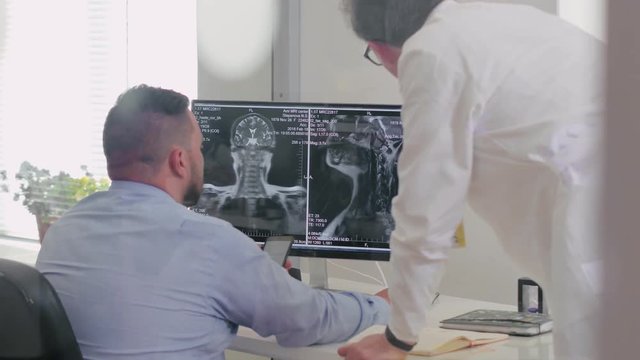 Doctors radiologists look at the computer screen x-ray picture of the patient. Digital diagnosis of diseases in modern medicine
