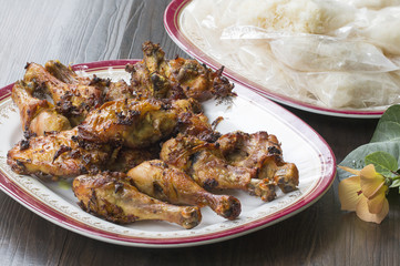 Thai food and traditional menu.Roast chicken and sticky rice with dish on wood.Close up.